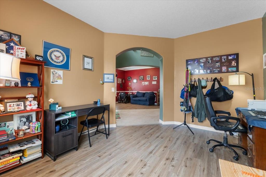 817 James Way Lake Alfred, FL 33850 - Photo 22 of 69 a view of a workspace with furniture and wooden floor
