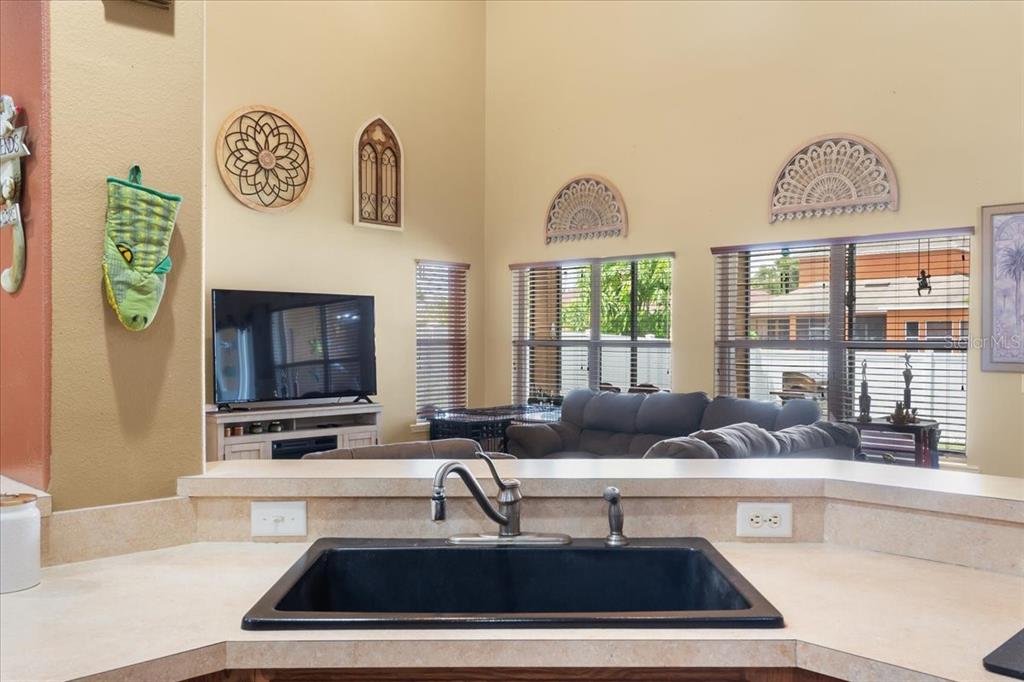 817 James Way Lake Alfred, FL 33850 - Photo 27 of 69 a kitchen with a sink a counter top space and living room area