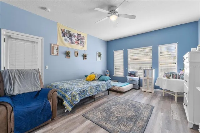 a bedroom with two beds and a chandelier