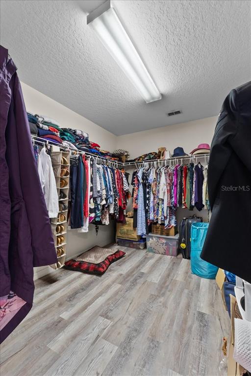 817 James Way Lake Alfred, FL 33850 - Photo 40 of 69 a view of walk in closet with clothes
