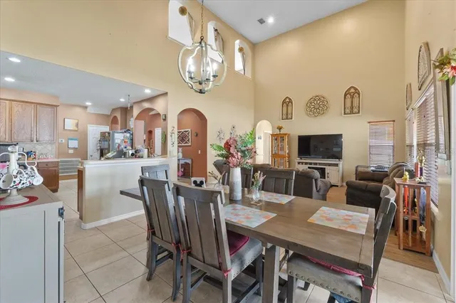 a kitchen with stainless steel appliances granite countertop a stove a sink dishwasher and a microwave oven with white cabinets