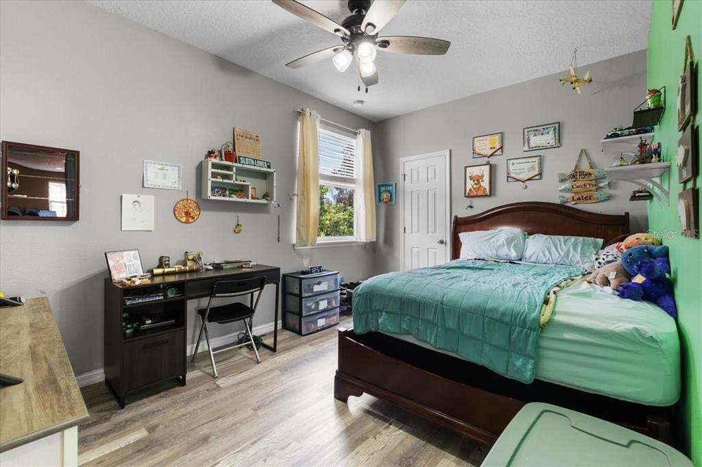 817 James Way Lake Alfred, FL 33850 - Photo 52 of 69 a bedroom with a bed and a chandelier