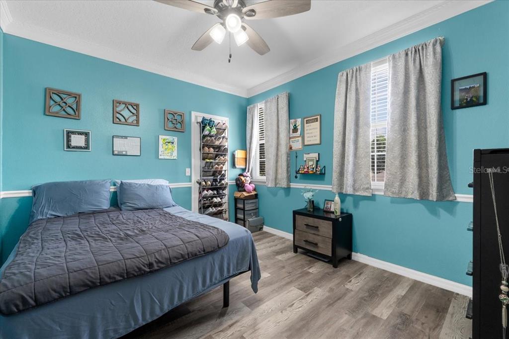 817 James Way Lake Alfred, FL 33850 - Photo 60 of 69 a bedroom with a bed and a chandelier