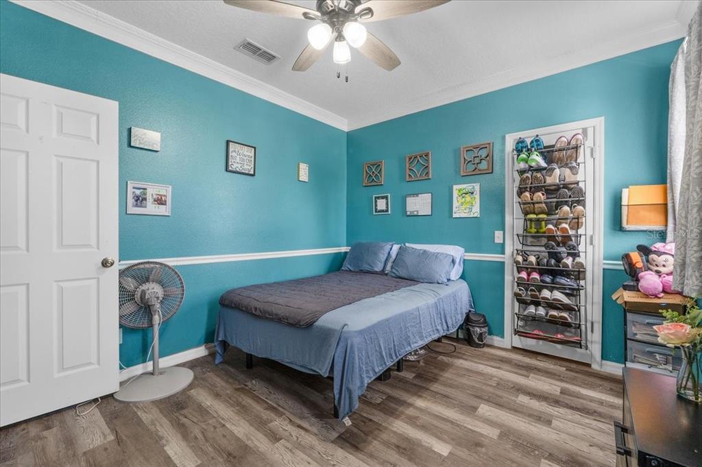 817 James Way Lake Alfred, FL 33850 - Photo 61 of 69 a bedroom with a bed and a chandelier