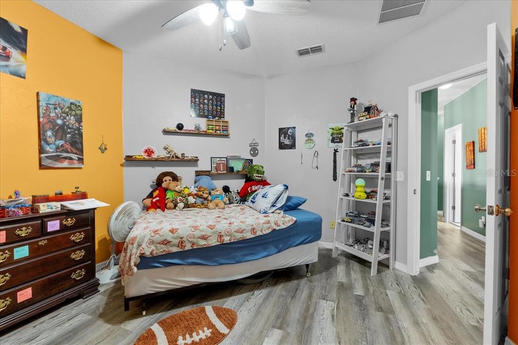 817 James Way Lake Alfred, FL 33850 - Photo 65 of 69 a bedroom with bed and a wooden floor