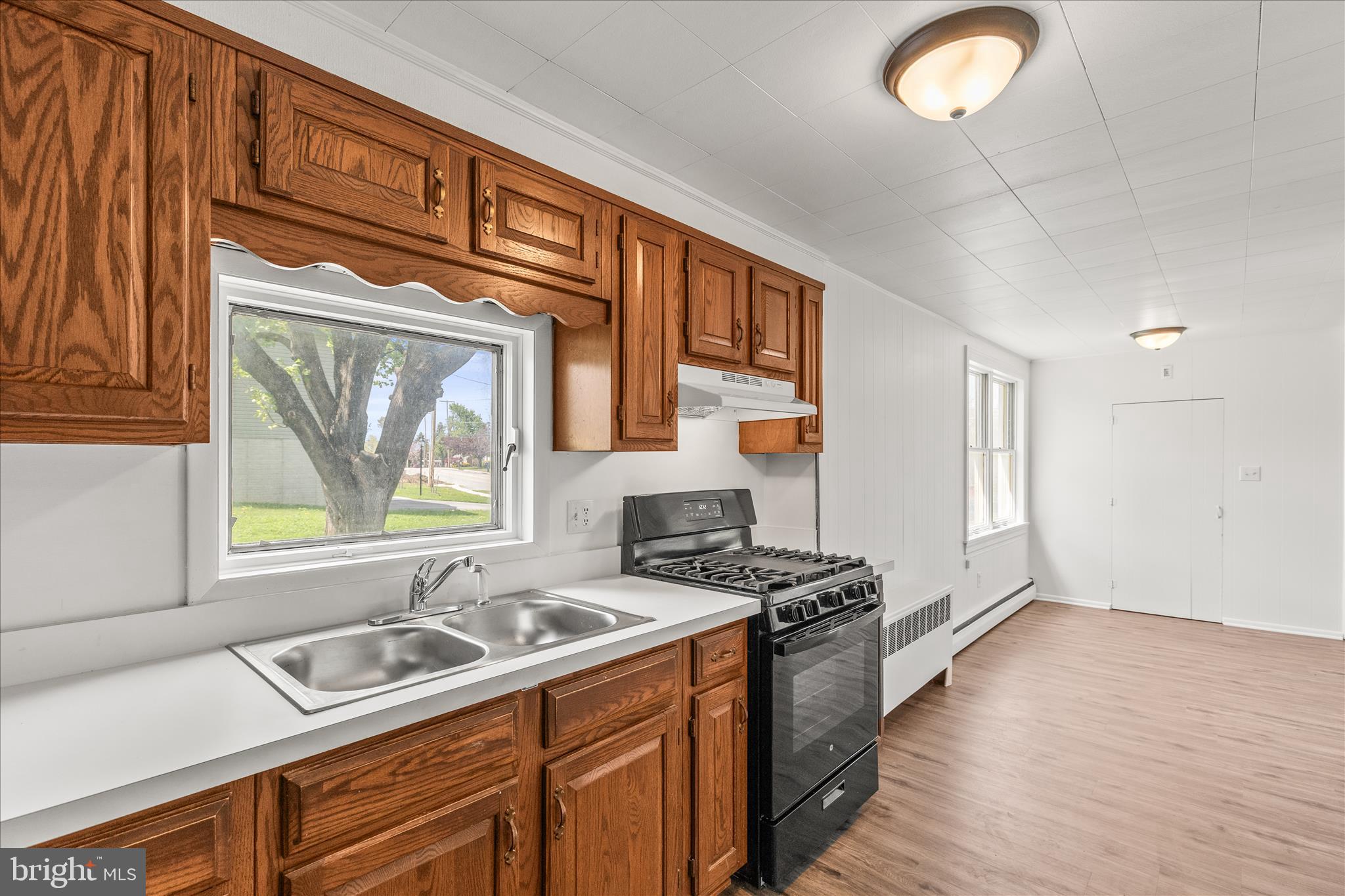 310 Clover Lane Hanover, PA 17331 - Photo 10 of 34 a kitchen that has a sink a stove and a wooden floor
