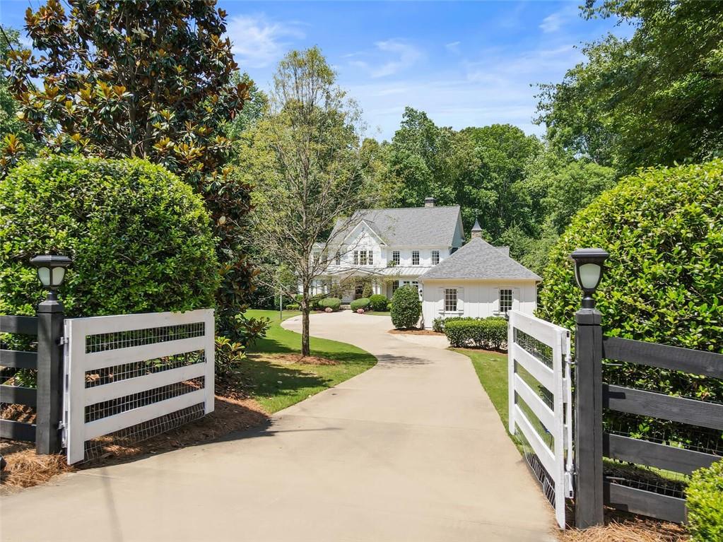 14980 South Thompson Road Milton, GA 30004 - Photo 1 of 1 a view of a house with backyard porch and sitting area