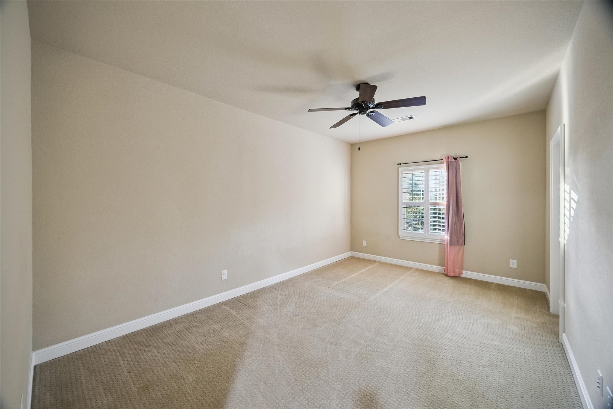 35 North Fremont Ridge Loop Spring, TX 77389 - Photo 22 of 37 Filled with natural light and enhanced by elegant plantation shutters, this generously sized secondary bedroom offers comfort, versatility, and ample space to accommodate a variety of lifestyles and needs.