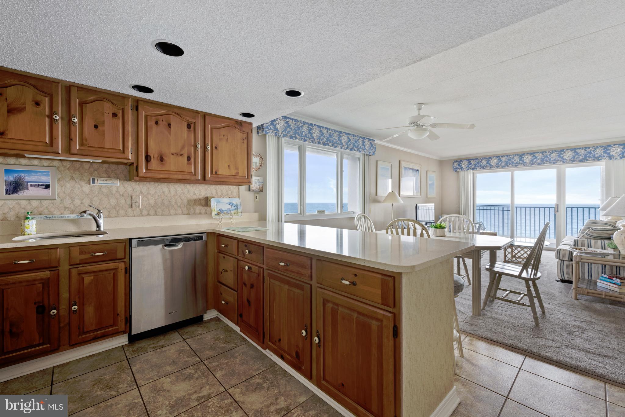 5 77th Street, Unit 404 Ocean City, MD 21842 - Photo 12 of 28 a kitchen with granite countertop a sink cabinets and window