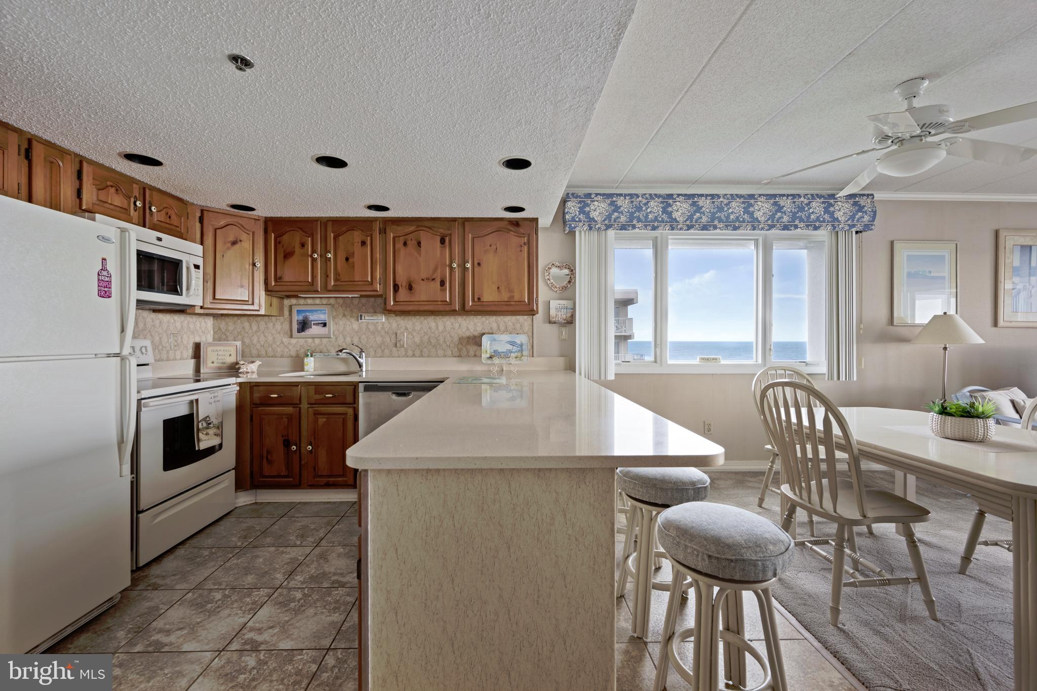 5 77th Street, Unit 404 Ocean City, MD 21842 - Photo 13 of 28 a kitchen with a sink appliances and cabinets