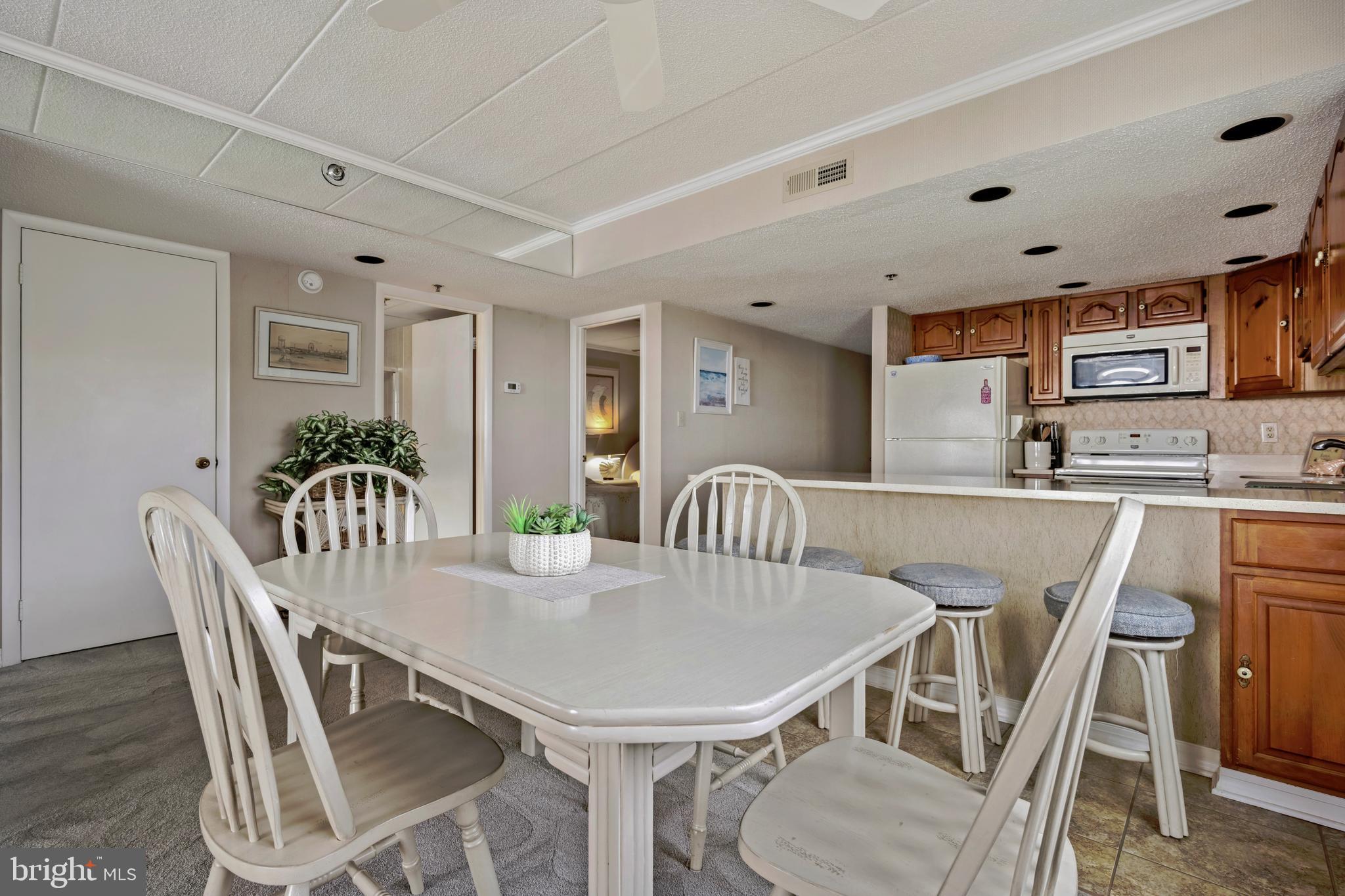 5 77th Street, Unit 404 Ocean City, MD 21842 - Photo 16 of 28 a view of a dining room with furniture and wooden floor