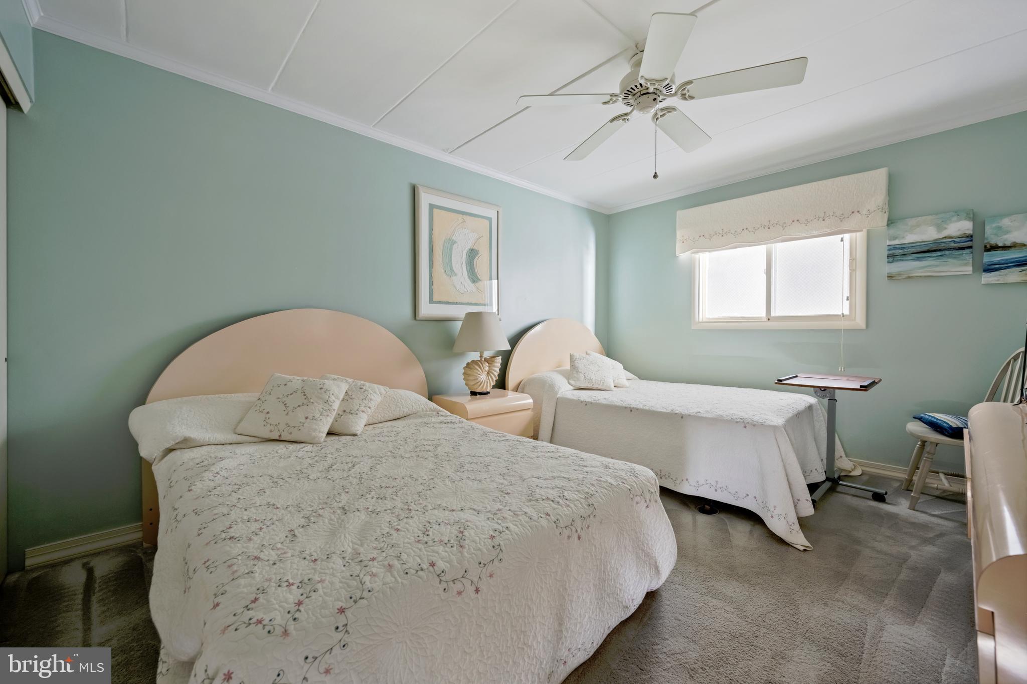 5 77th Street, Unit 404 Ocean City, MD 21842 - Photo 23 of 28 a bedroom with two beds and ceiling fan