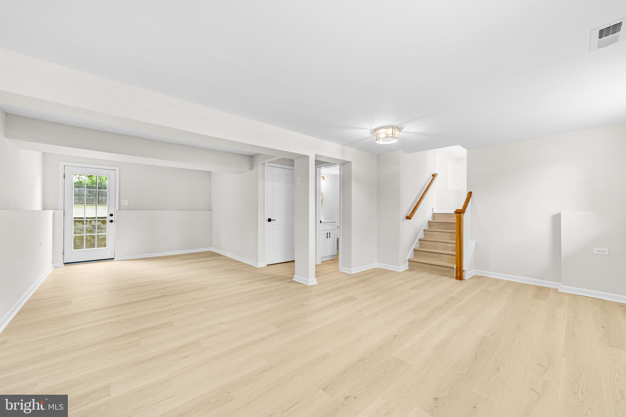 15 Dunlin Way Sicklerville, NJ 08081 - Photo 13 of 28 a view of an empty room with wooden floor and stairs