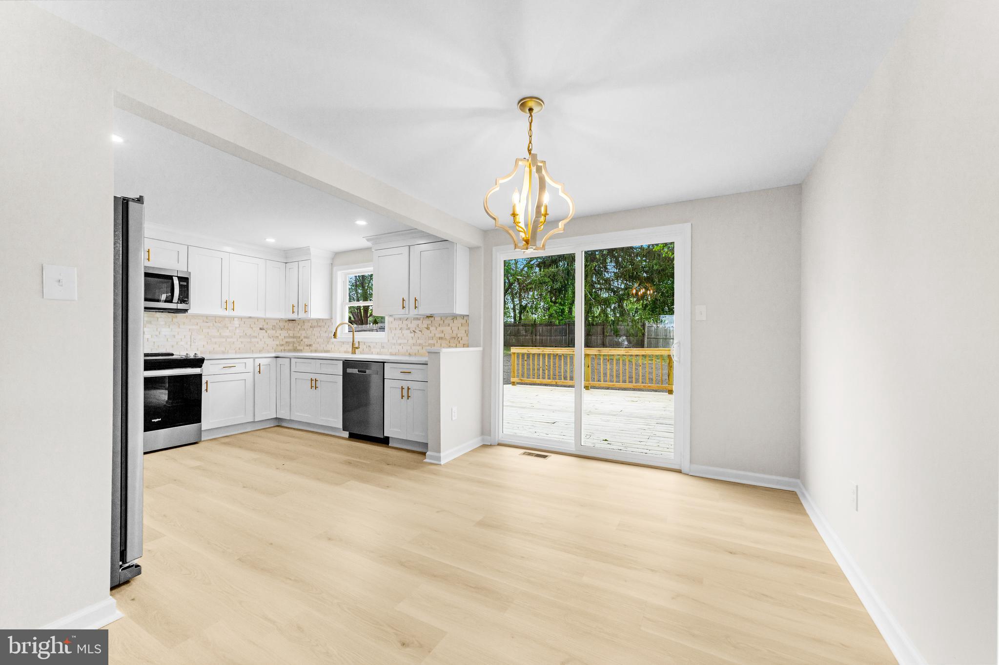 15 Dunlin Way Sicklerville, NJ 08081 - Photo 7 of 28 a large white kitchen with a sink and chandelier