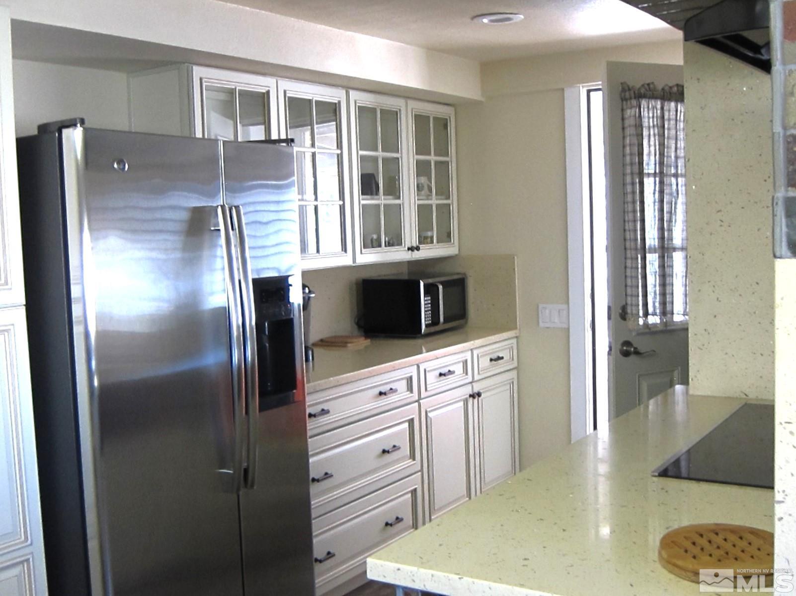 16770 Mt Rose Highway, Unit A & B Reno, NV 89511 - Photo 14 of 40 a kitchen with stainless steel appliances granite countertop a refrigerator and a sink