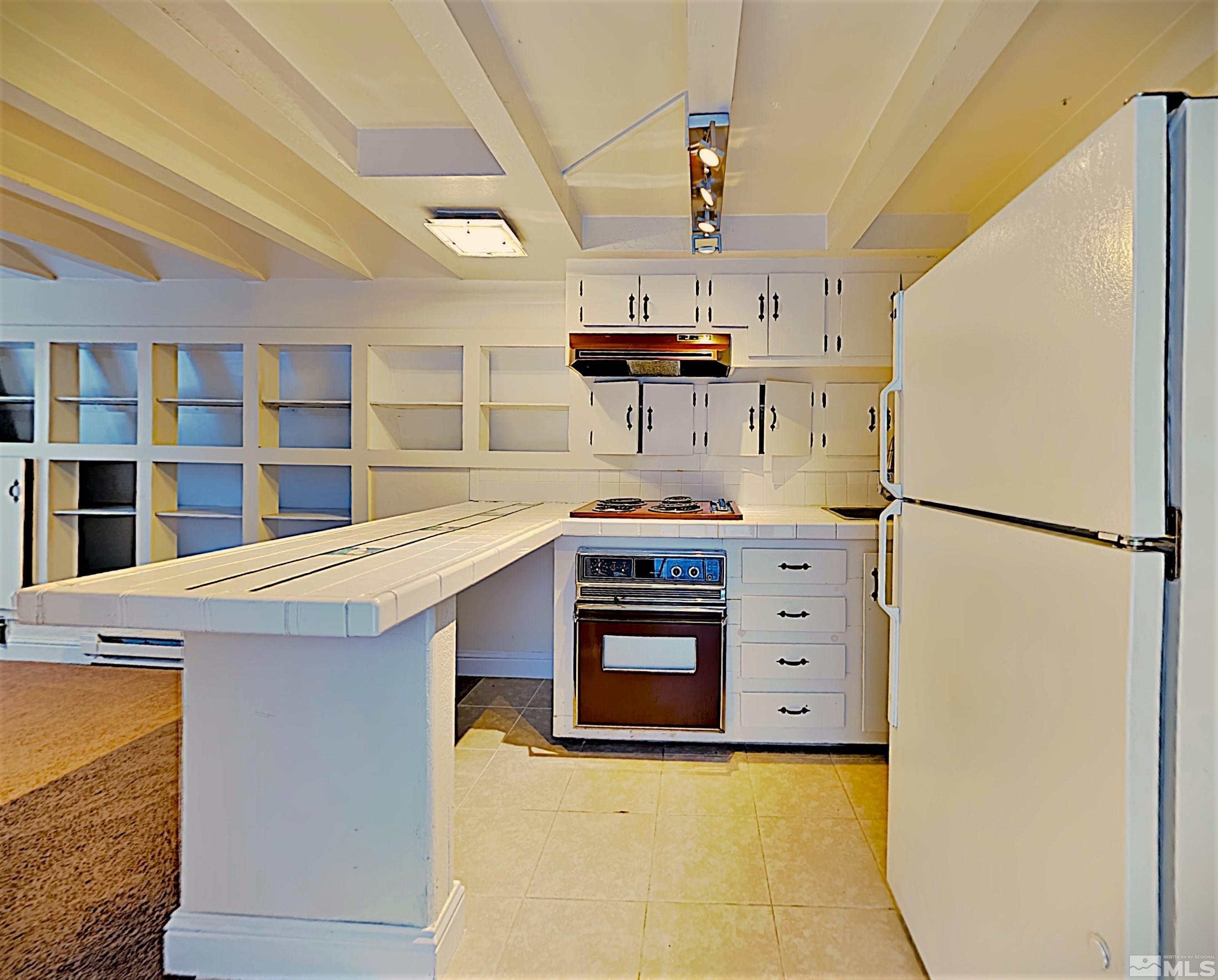 16770 Mt Rose Highway, Unit A & B Reno, NV 89511 - Photo 25 of 40 a kitchen with stainless steel appliances a stove a refrigerator and cabinets