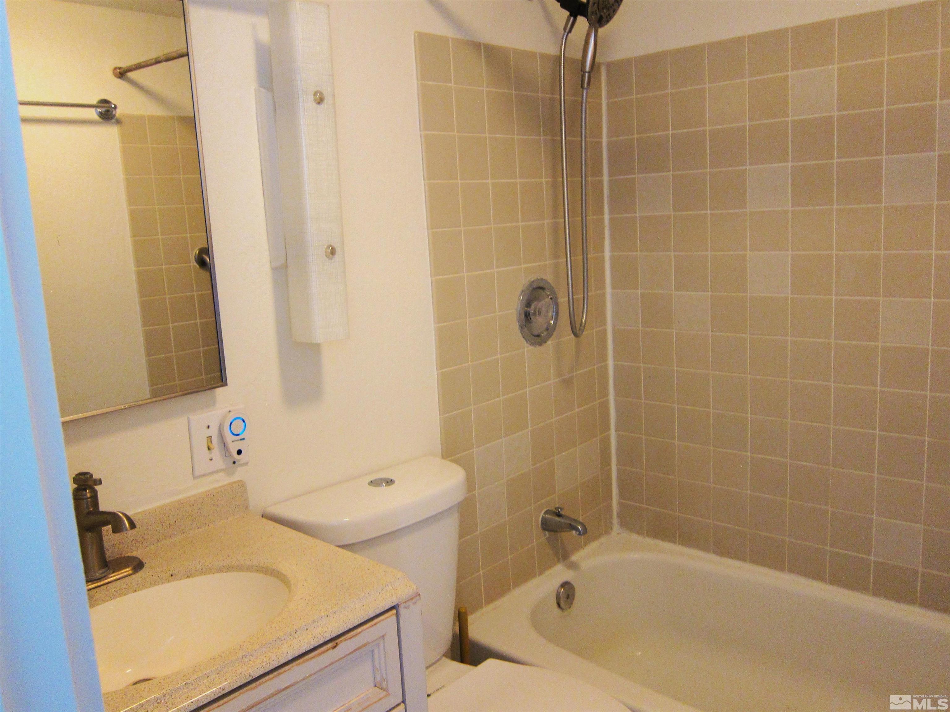16770 Mt Rose Highway, Unit A & B Reno, NV 89511 - Photo 26 of 40 a bathroom with a sink a toilet and shower