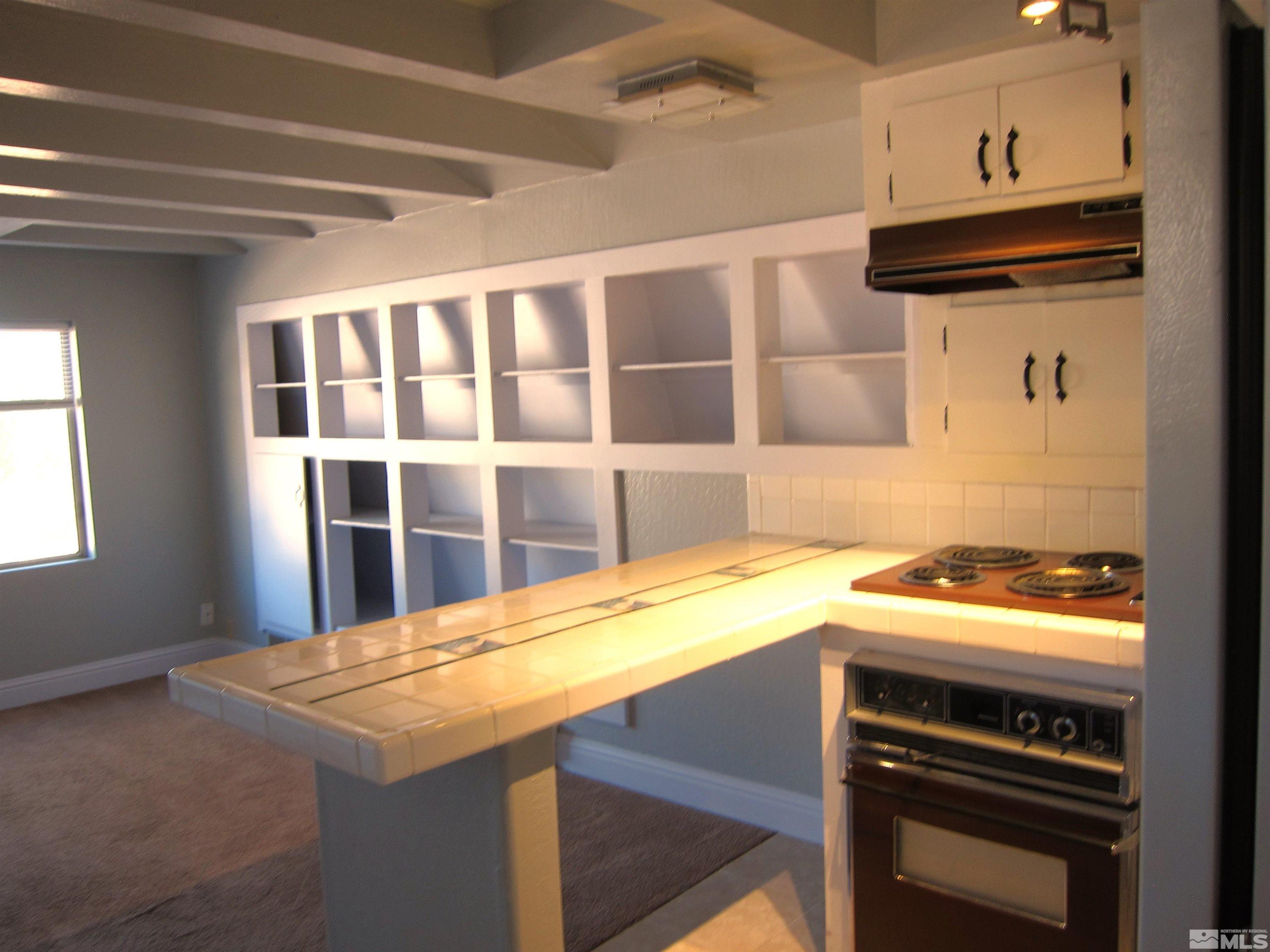 16770 Mt Rose Highway, Unit A & B Reno, NV 89511 - Photo 27 of 40 a kitchen with a stove and a microwave