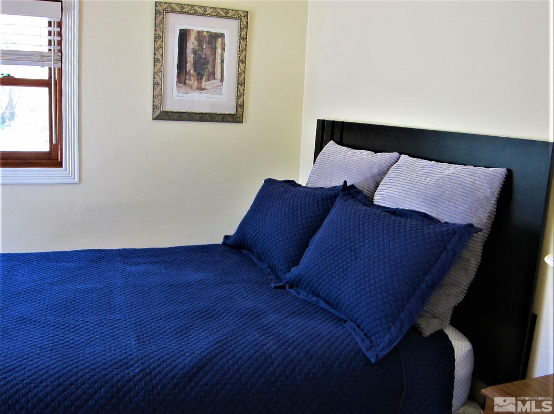 16770 Mt Rose Highway, Unit A & B Reno, NV 89511 - Photo 30 of 40 a bed sitting in a bedroom next to a window
