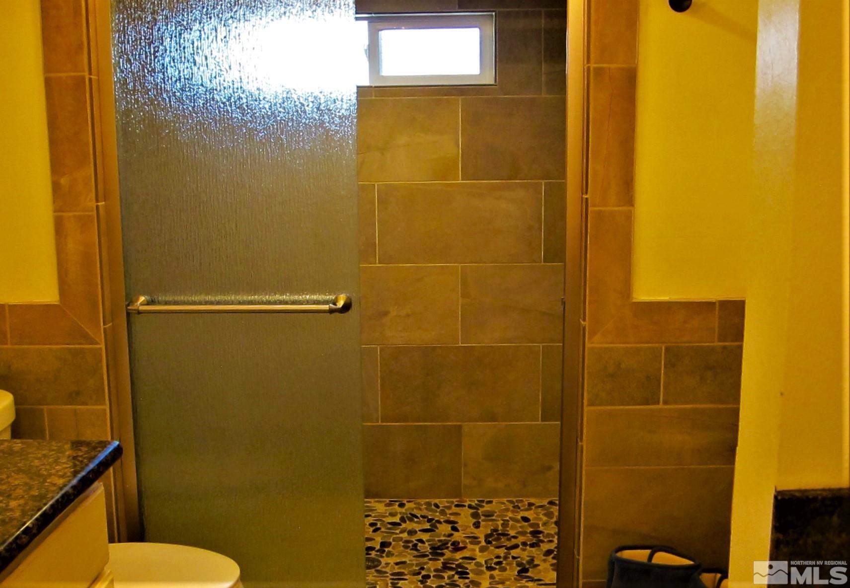 16770 Mt Rose Highway, Unit A & B Reno, NV 89511 - Photo 33 of 40 a bathroom with a blue shower