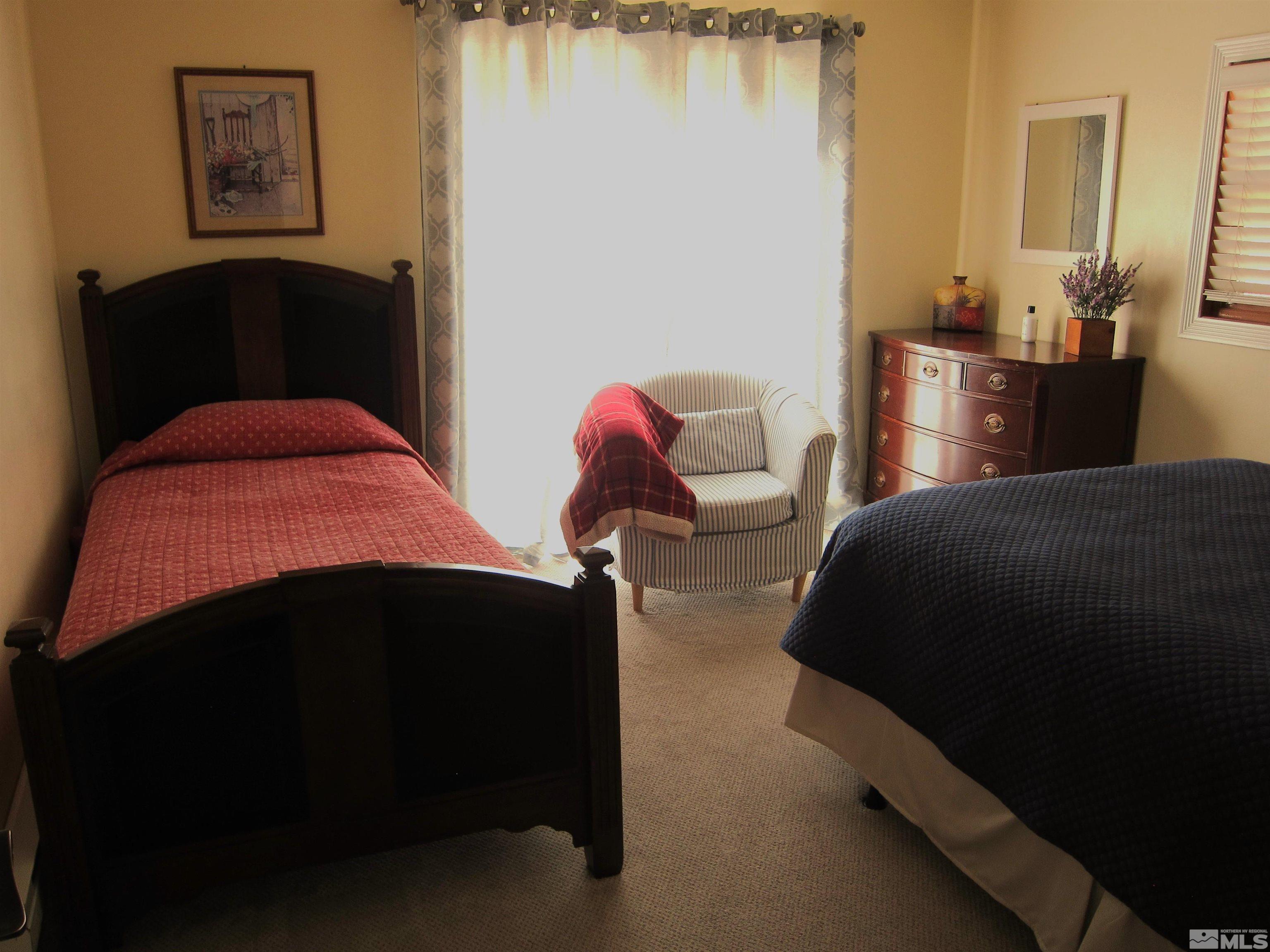 16770 Mt Rose Highway, Unit A & B Reno, NV 89511 - Photo 34 of 40 a bedroom with a bed and a painting on the wall