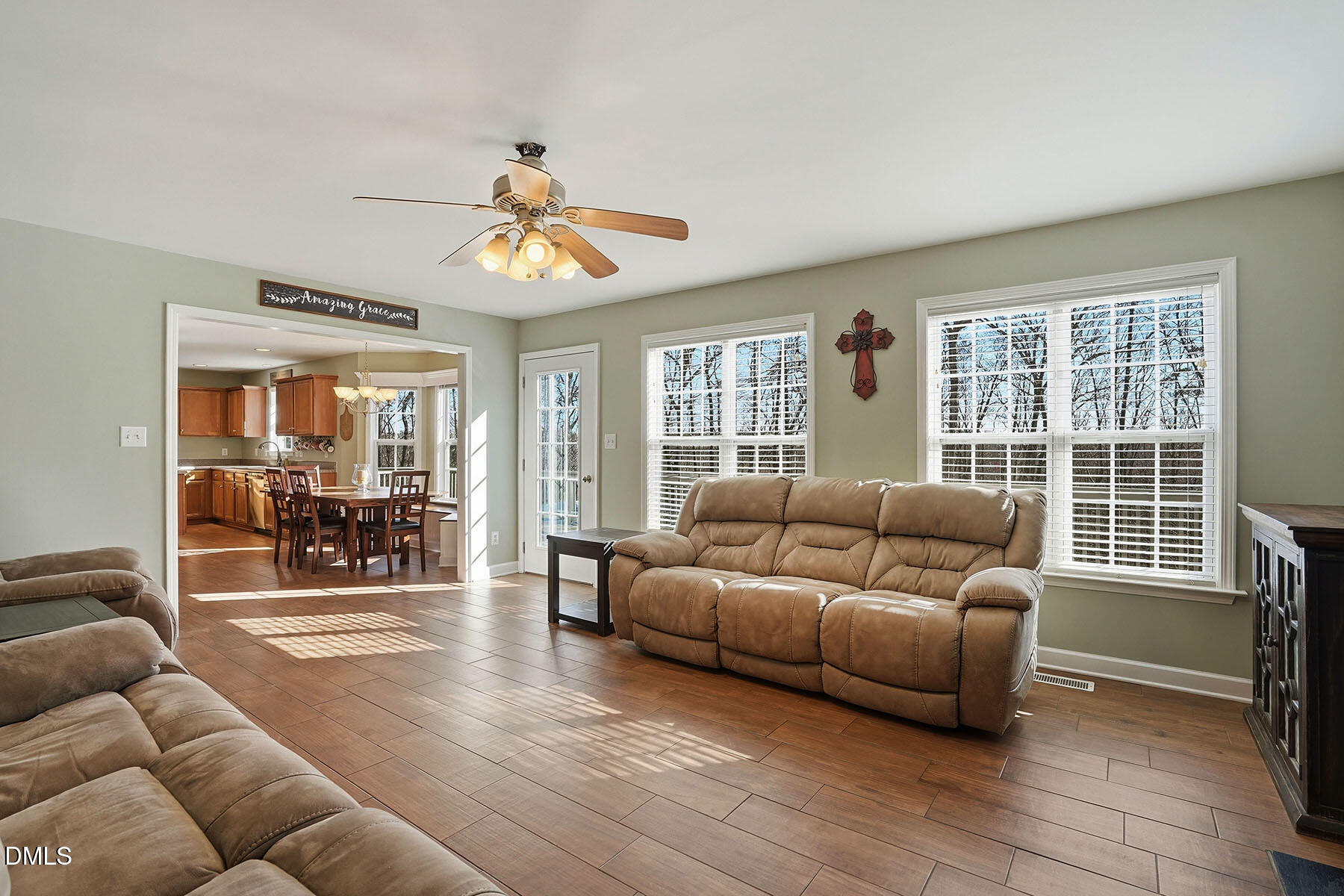 90 Spring Leaf Lane Wendell, NC 27591 - Photo 13 of 37 a living room with furniture a chandelier and a floor to ceiling window