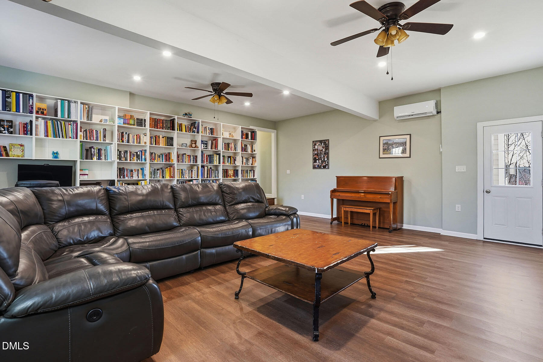 90 Spring Leaf Lane Wendell, NC 27591 - Photo 16 of 37 a living room with furniture a ceiling fan and a bookshelf