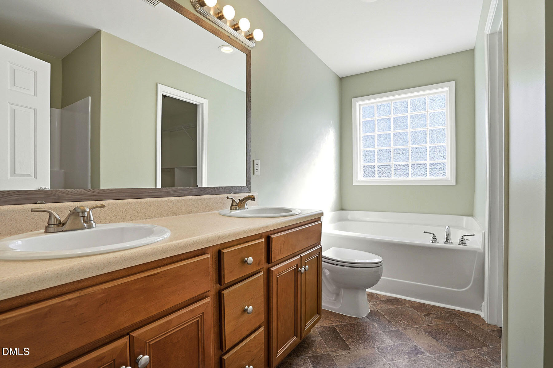 90 Spring Leaf Lane Wendell, NC 27591 - Photo 19 of 37 a bathroom with a double vanity sink toilet mirror and bathtub