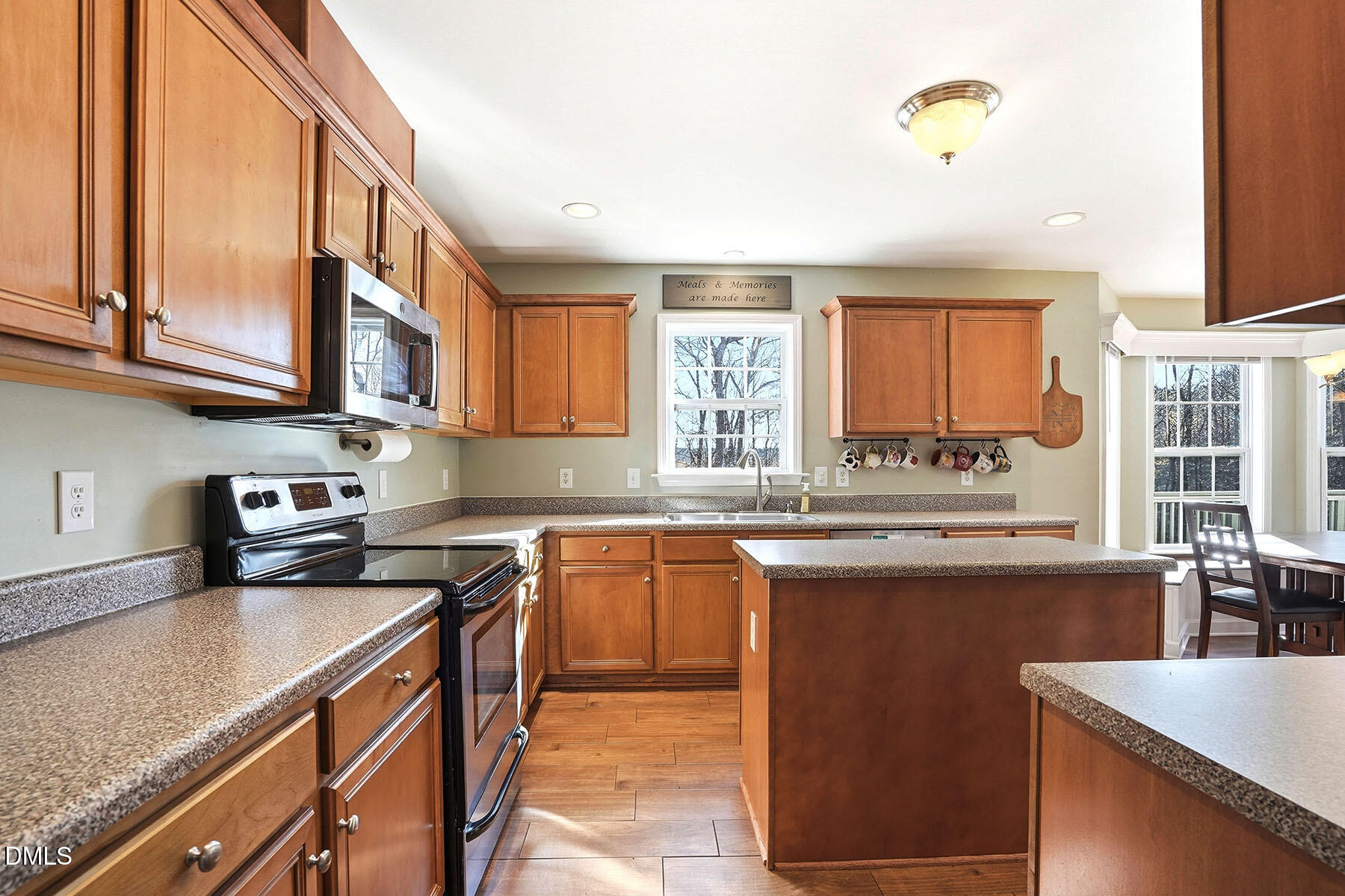 90 Spring Leaf Lane Wendell, NC 27591 - Photo 7 of 37 a kitchen with stainless steel appliances granite countertop a sink stove and cabinets
