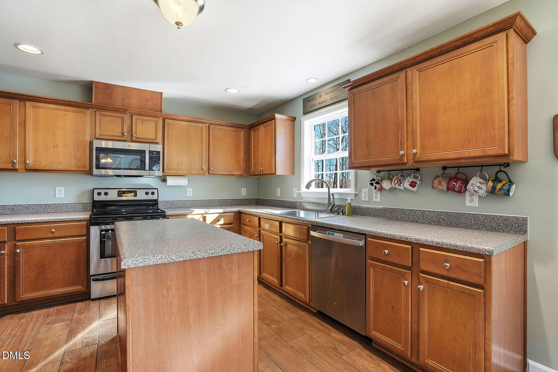 90 Spring Leaf Lane Wendell, NC 27591 - Photo 9 of 37 a kitchen with stainless steel appliances granite countertop wooden cabinets a stove top oven a sink and dishwasher