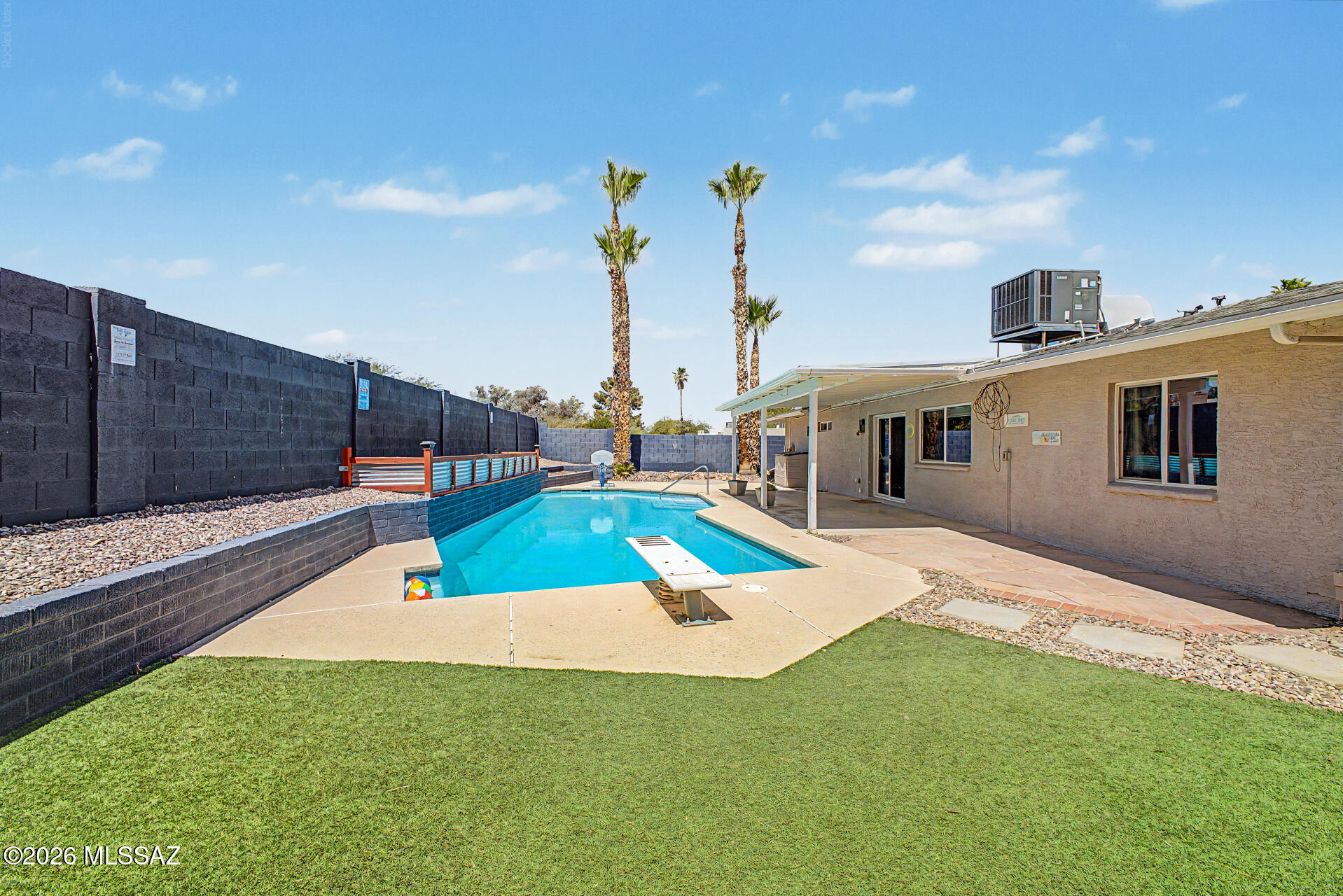 7550 East Rio Verde Drive Tucson, AZ 85715 - Photo 25 of 25 Whether diving in, playing on the turf, or relaxing poolside, this backyard is built for making memories.