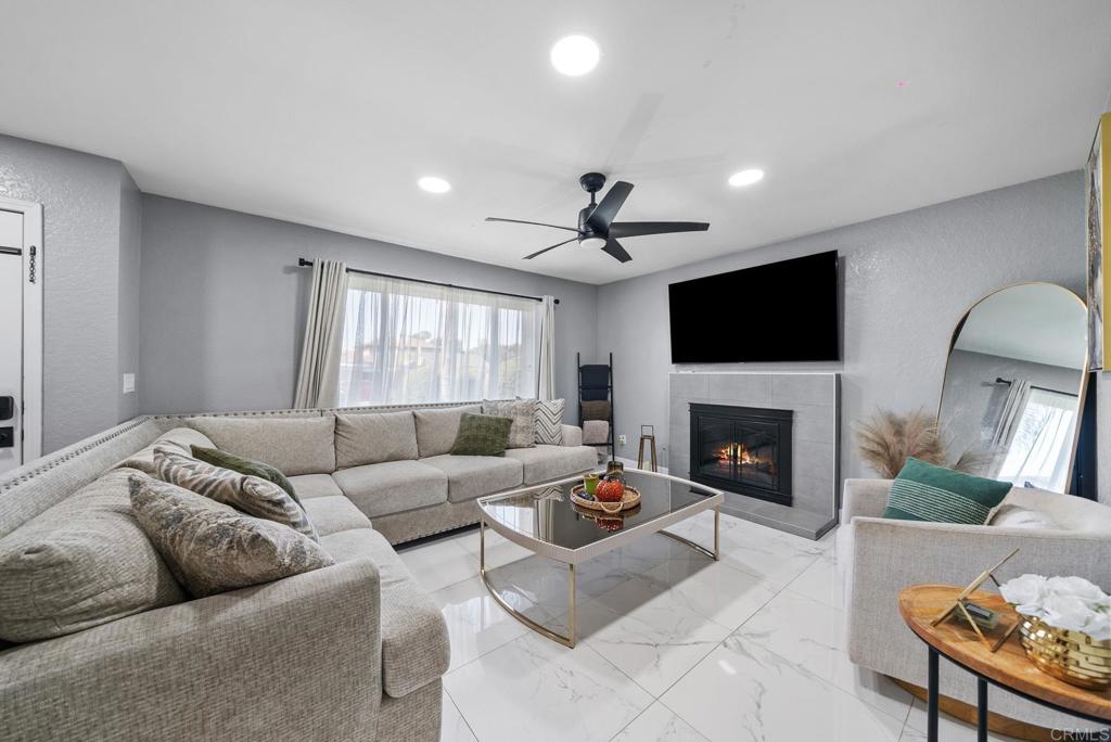 1841 International Road San Diego, CA 92154 - Photo 1 of 1 a living room with furniture a fireplace and a flat screen tv