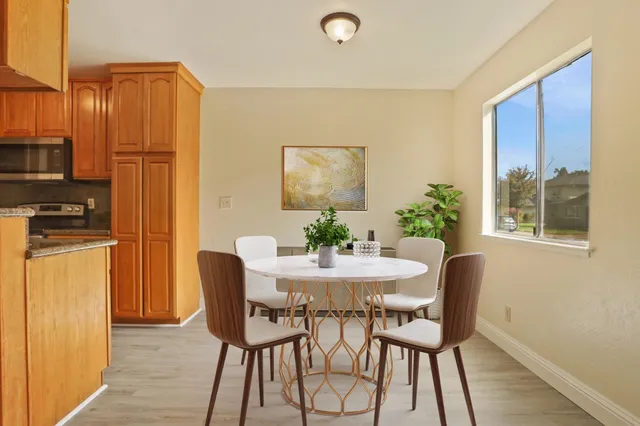 a dining room with furniture and window