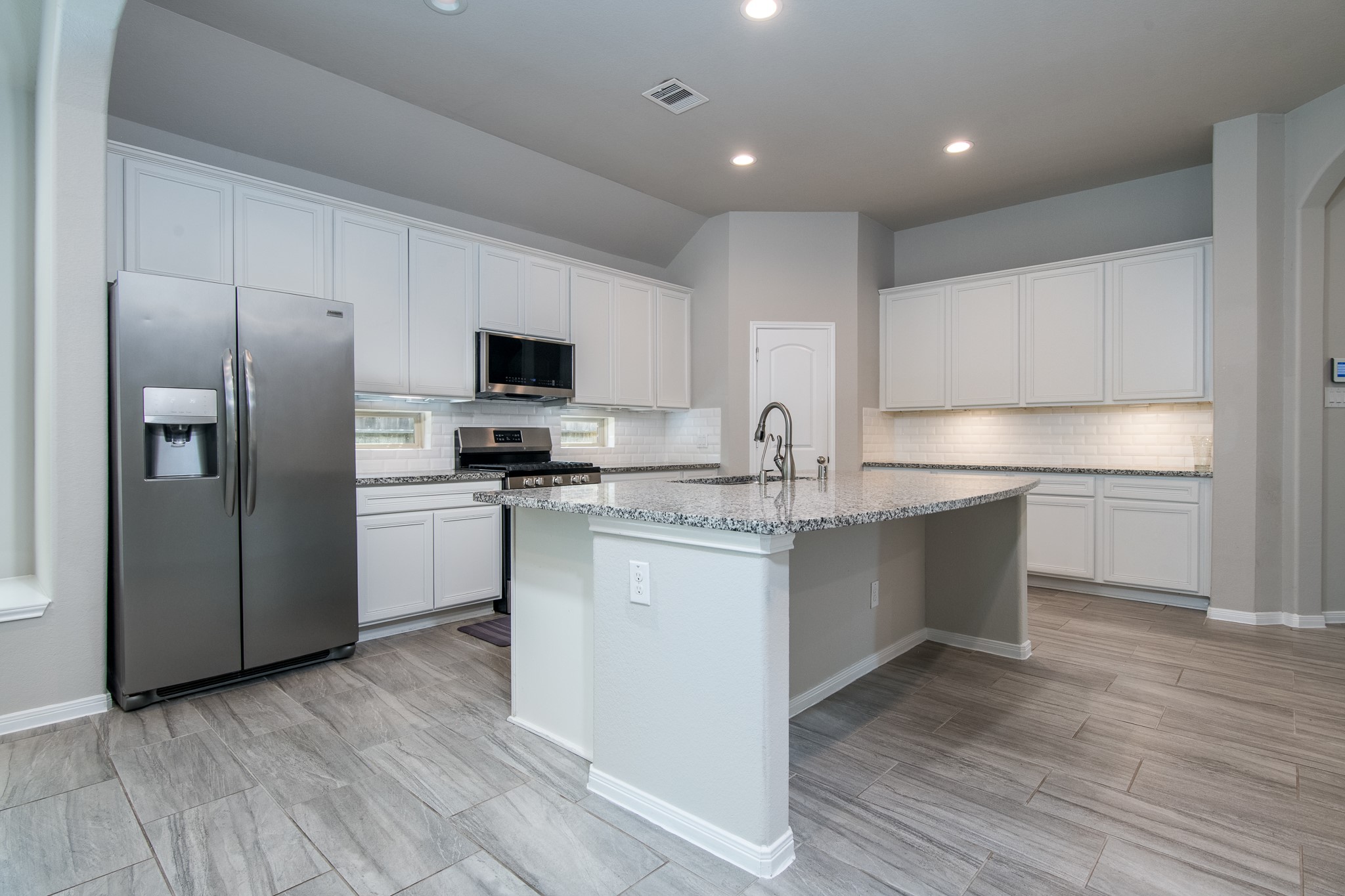 3211 Discovery Lane Conroe, TX 77301 - Photo 9 of 22 Lovely kitchen with tons of cabinets, stainless steel appliances and granite counter tops