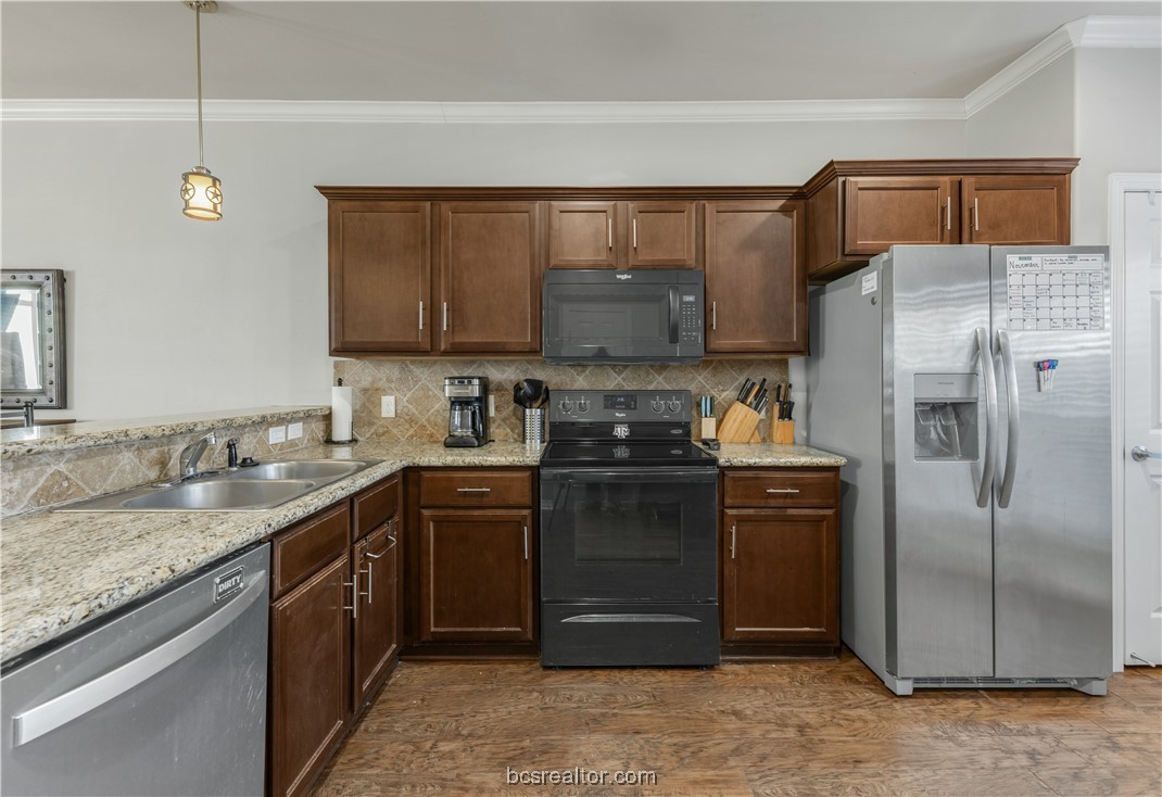 1198 Jones-Butler Road, Unit 1807 College Station, TX 77840 - Photo 11 of 24 a kitchen with a refrigerator and a sink