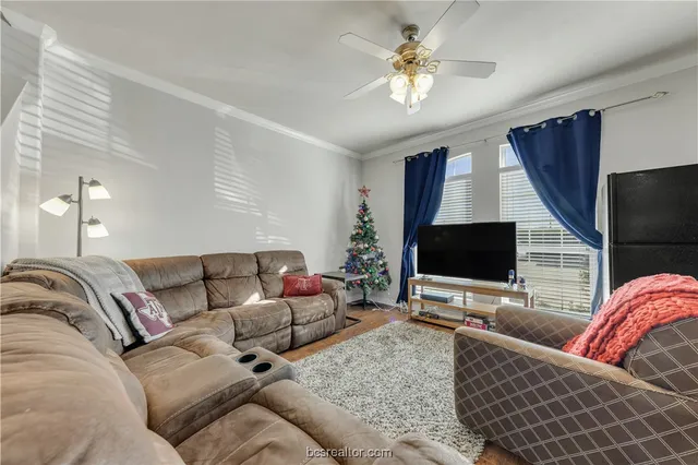 a living room with furniture and a flat screen tv