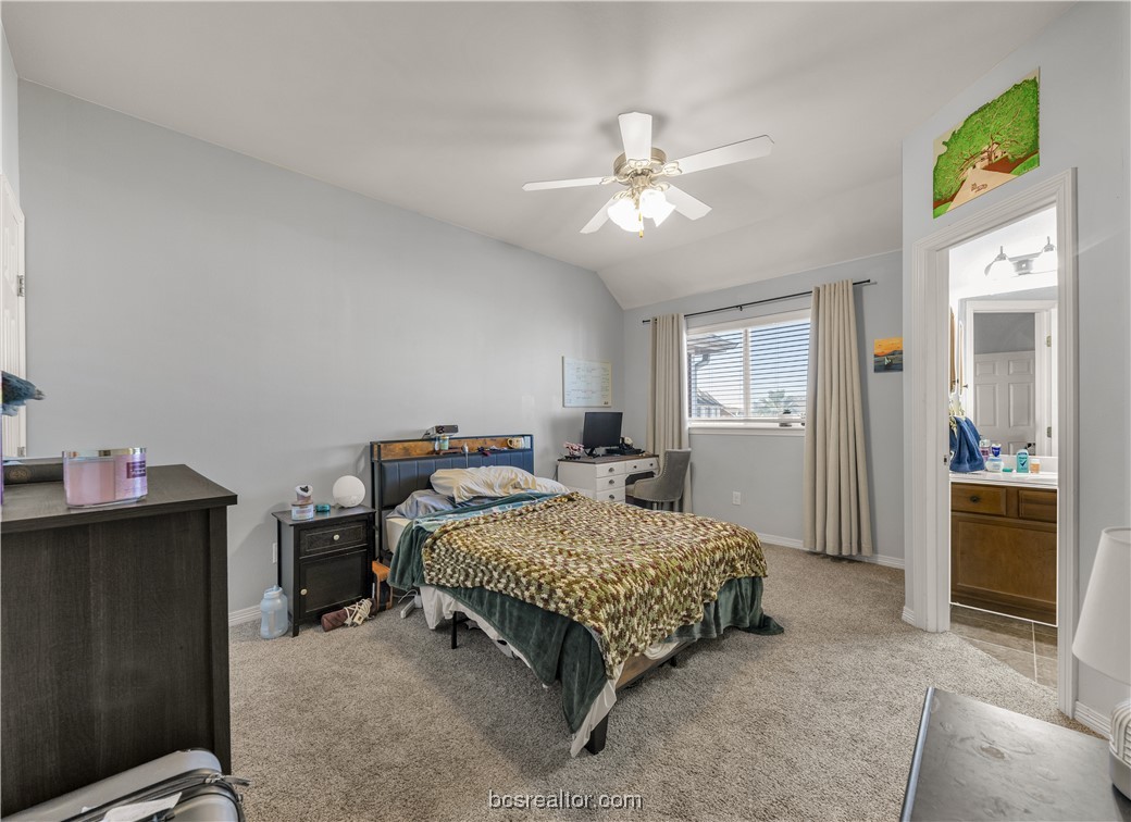 1198 Jones-Butler Road, Unit 1807 College Station, TX 77840 - Photo 23 of 24 a bedroom with a bed and a chandelier