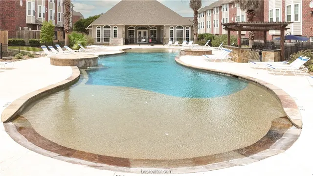 a view of a swimming pool with a yard