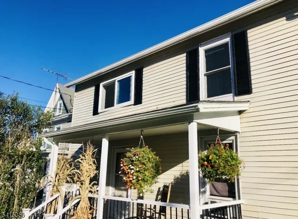 a front view of a house with plants