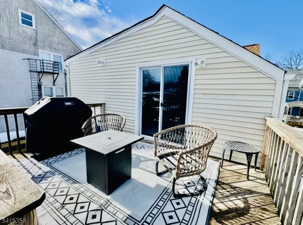 a roof deck with a table and chairs