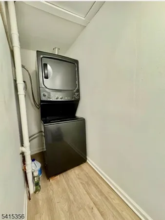 a living room with a chair and a wooden floor