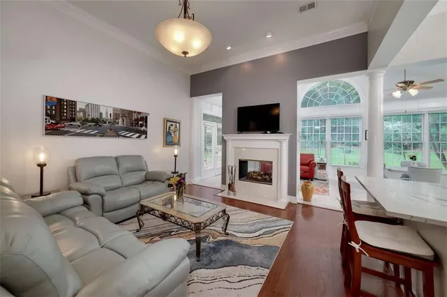 a living room with furniture a fireplace and a flat screen tv