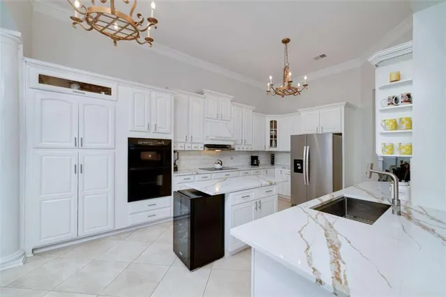 a kitchen with stainless steel appliances a refrigerator sink and cabinets
