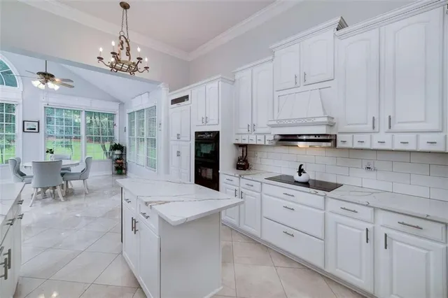 a kitchen with stainless steel appliances kitchen island granite countertop a sink and cabinets