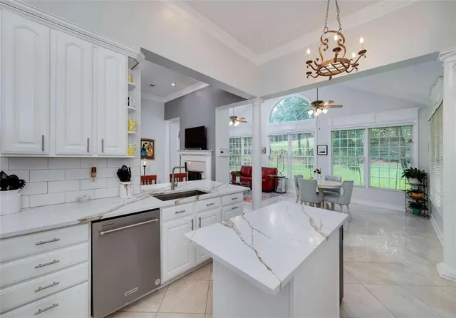 a kitchen with granite countertop a sink stainless steel appliances and cabinets