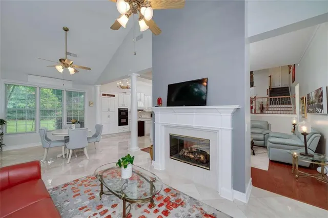 a living room with furniture a fireplace and a flat screen tv