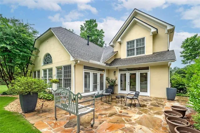 a view of a house with backyard and sitting area