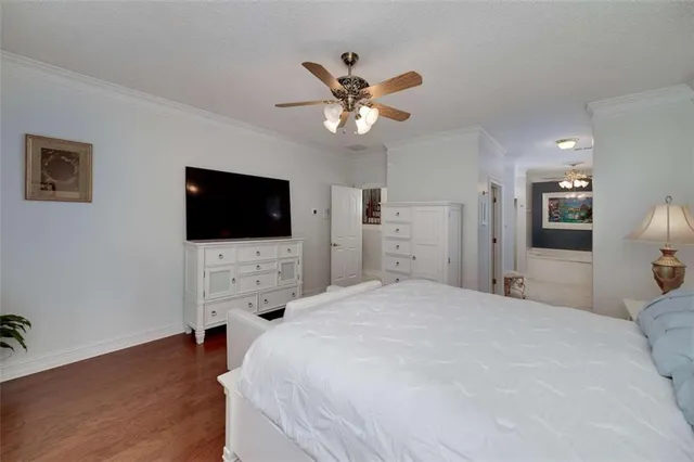 a bedroom with a bed tv and a flat screen tv