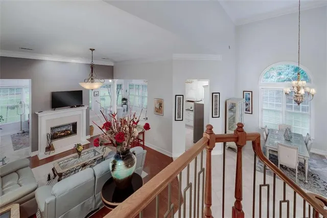 a view of a hallway to a livingroom with furniture