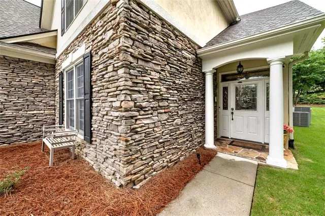 a front view of a house with a garden